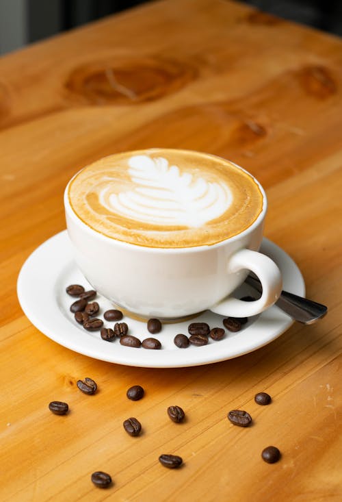 White Ceramic Cup With Cappuccino on Saucer