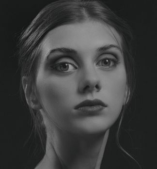 Grayscale portrait of a young woman with an expressive gaze in Kyiv, Ukraine.