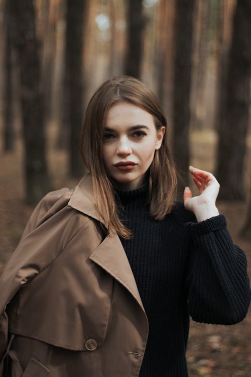 Woman in Brown Coat and Knitted Sweater Posing