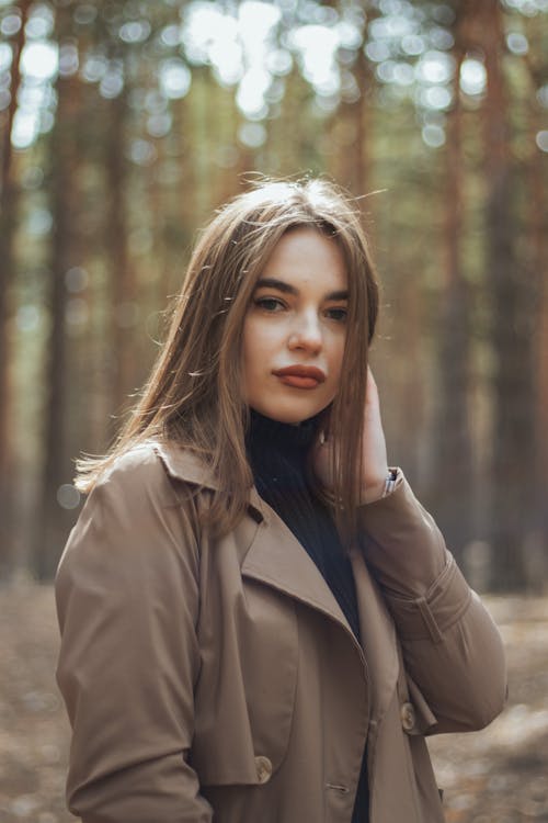 Woman in Brown Coat Standing Near Trees