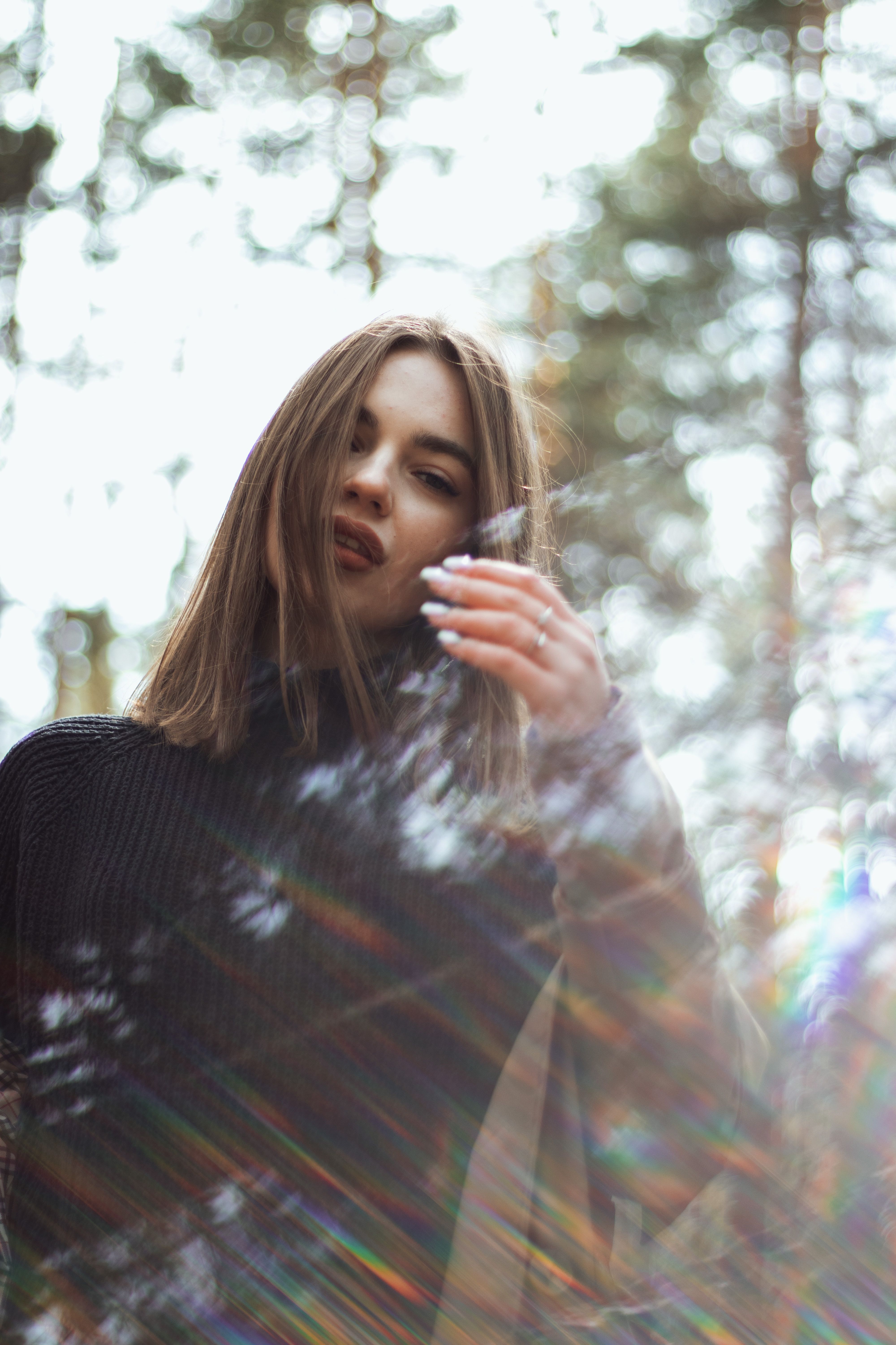 A Woman in Black Sweater Standing Near Trees · Free Stock Photo
