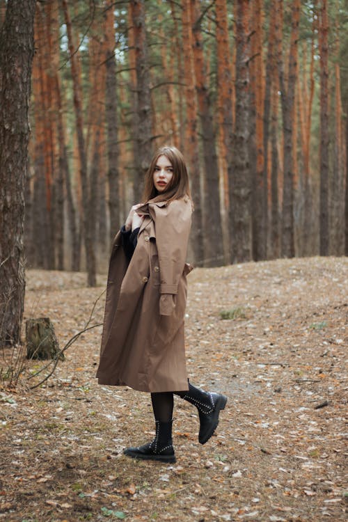 Woman in Brown Coat Standing on Forest