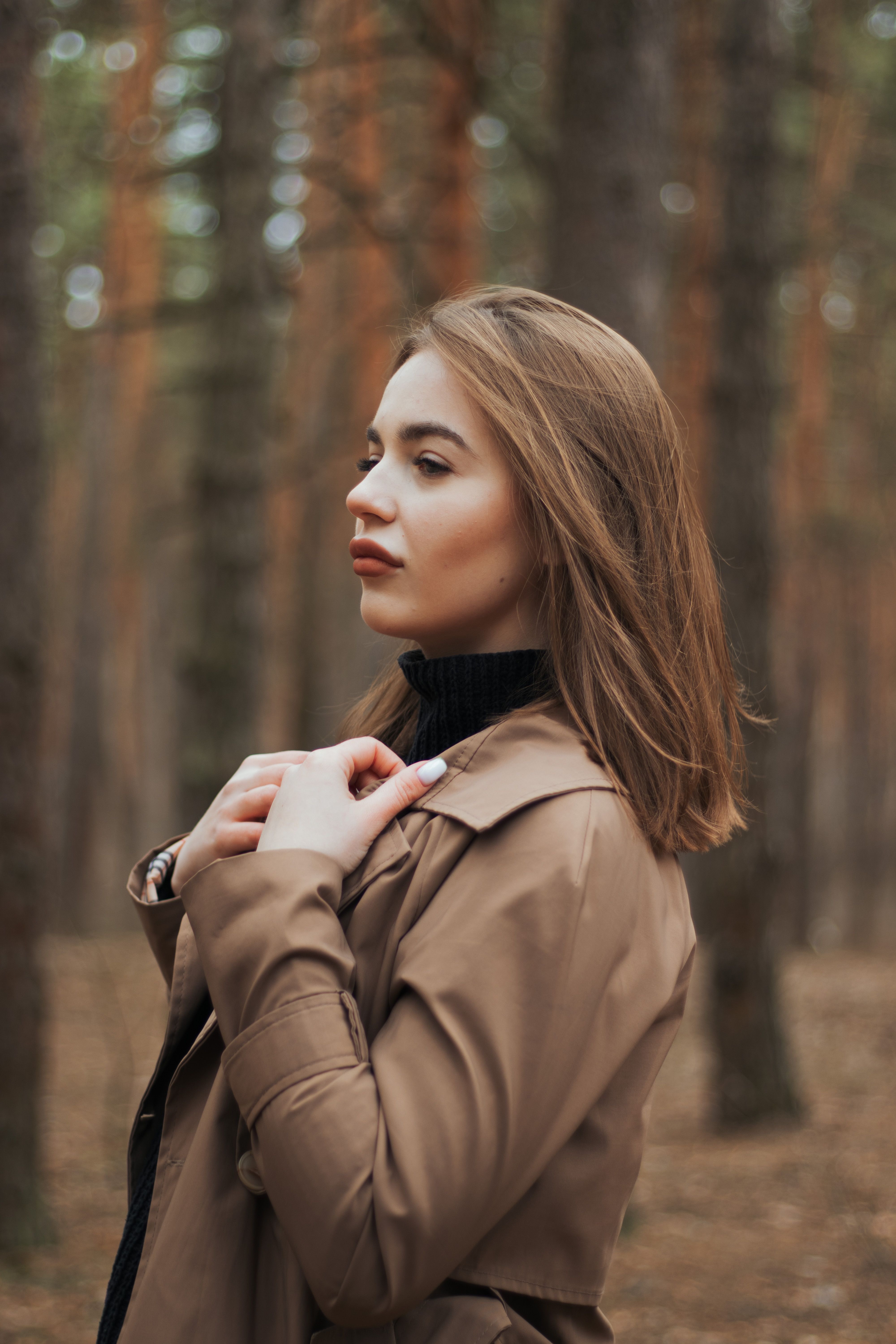 Woman in Brown Coat Standing in the Woods · Free Stock Photo