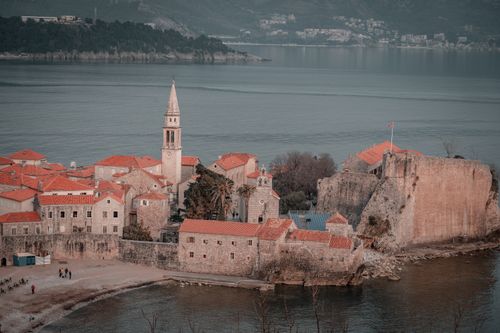 Free Aerial view of historic Old Town Budva in Montenegro with iconic red roofs and Adriatic backdrop. Stock Photo