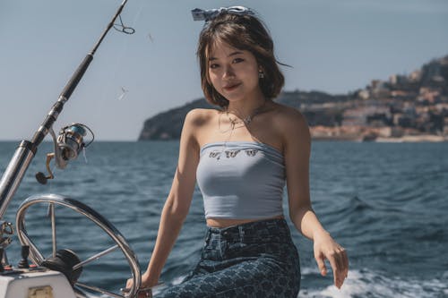 Woman in Tube Top Sitting on a Boat