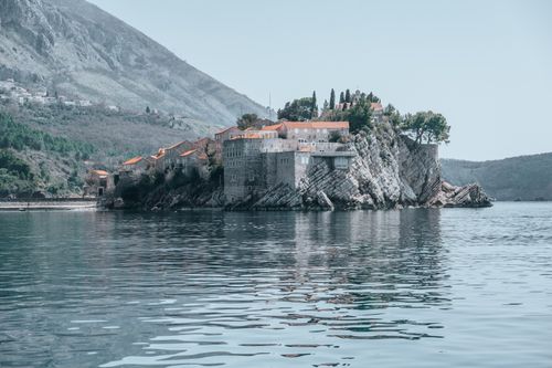 Free Breathtaking view of Sveti Stefan, Montenegro, showcasing its historic stone houses and serene Adriatic Sea. Stock Photo