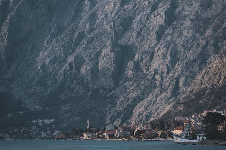 Seaside Town At Foot Of Majestic Mountain