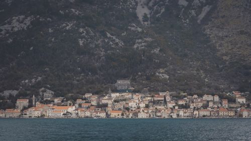 Free Beautiful coastal town of Kotor with rocky mountain backdrop and calm sea view. Stock Photo