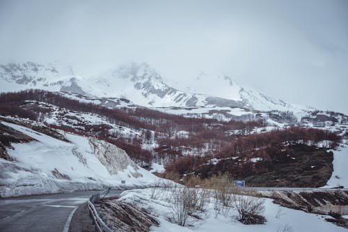 Asphalt Road Across the Snow Covered Mountain