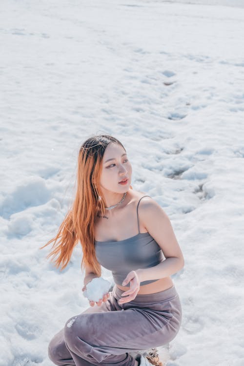 Woman Pose While Holding a Snow 