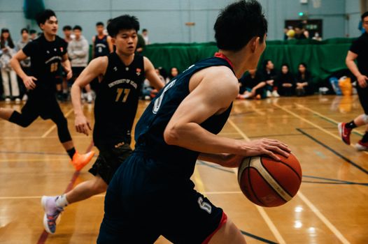 Fast-paced basketball game capturing players in action on an indoor court.
