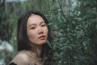 Pretty Woman Beside a Green Plant