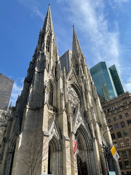 Free Vertical view of St. Patrick's Cathedral, New York, showcasing Gothic architecture against a bright sky. Stock Photo