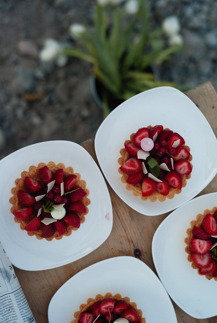 Top View Of Strawberry Meals On White Plates