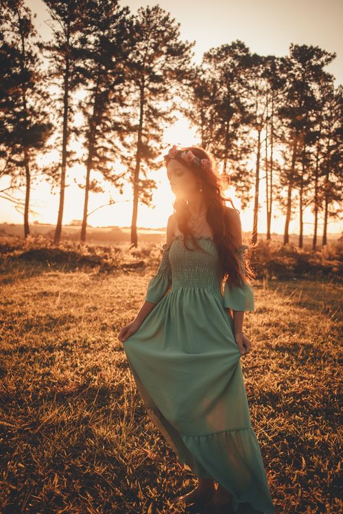 A Woman in Teal Dress Standing on the Grass Field · Free Stock Photo