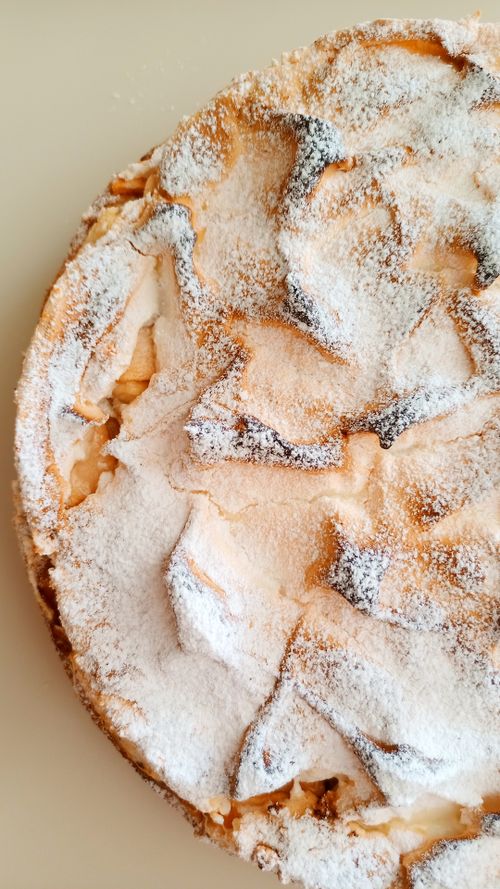 Free Close-up of a freshly baked homemade apple pie with powdered sugar topping. Stock Photo