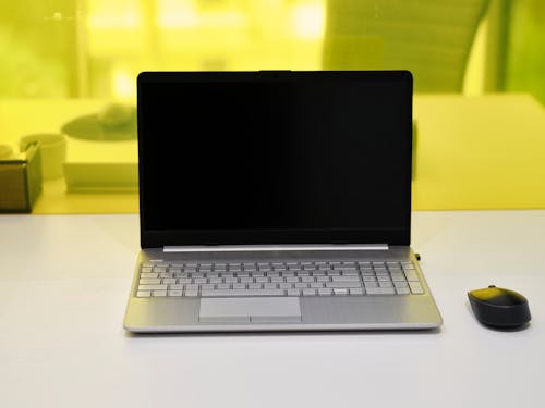 Free Gray Laptop with Blank Screen on White Table Stock Photo