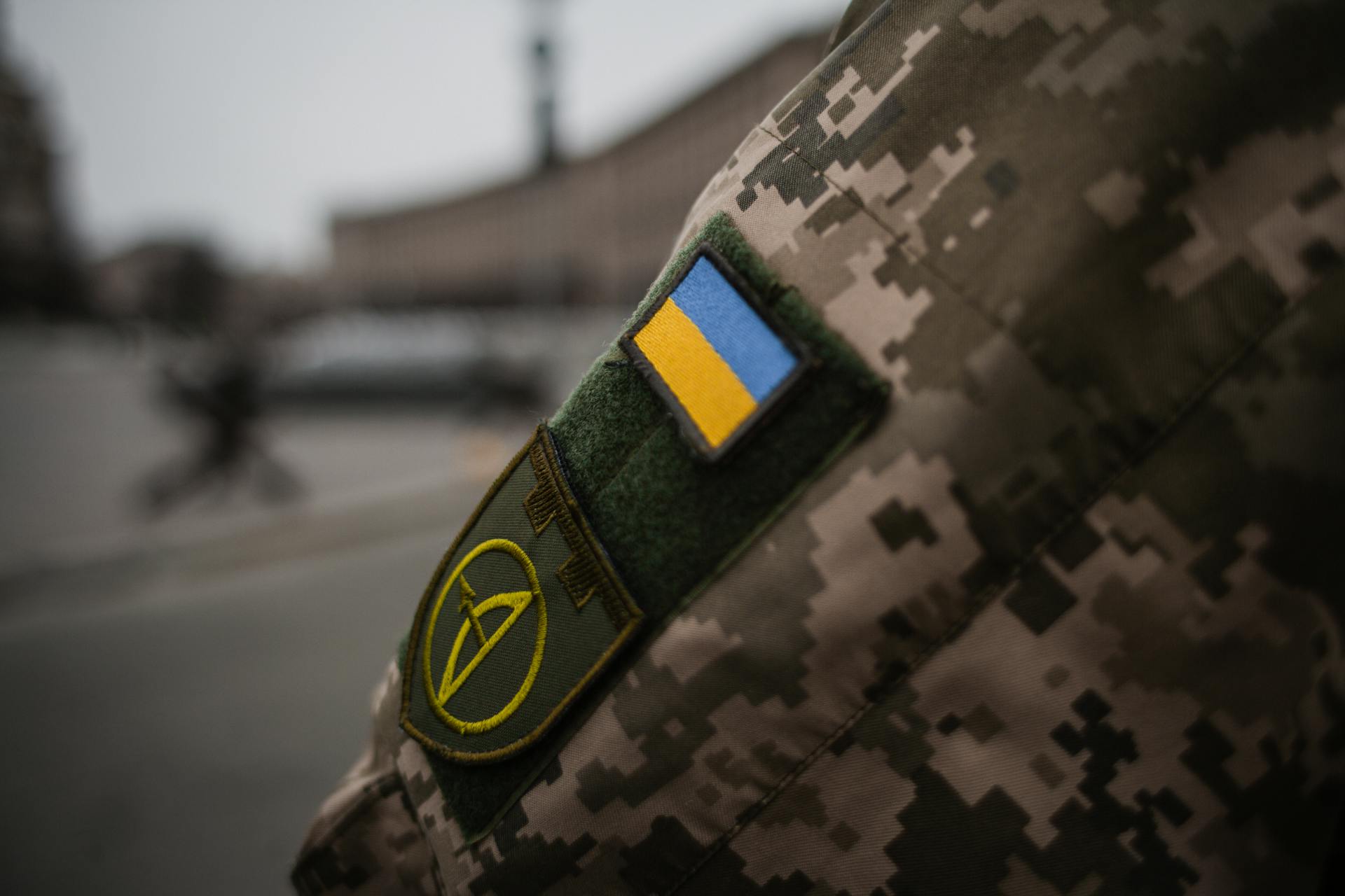 Detailed shot of Ukrainian military uniform with flag patch, symbolizing national pride.