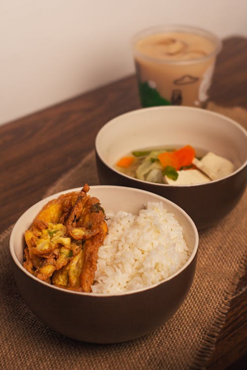 Cold Drink and Fried Chicken with Rice and Soup on Brown Ceramic Bowls