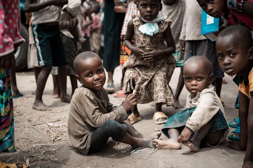 Close-Up Shot of Children Sitting on the Ground