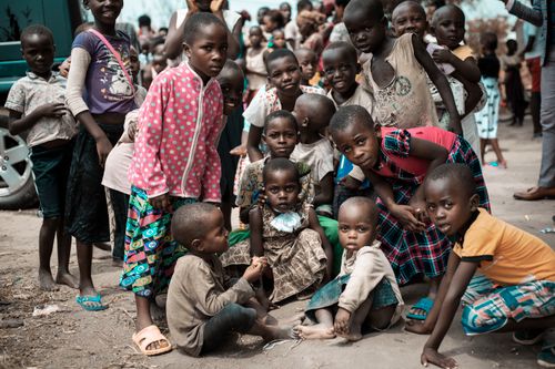 Free A group of African children gathered outdoors, showcasing community and innocence. Stock Photo