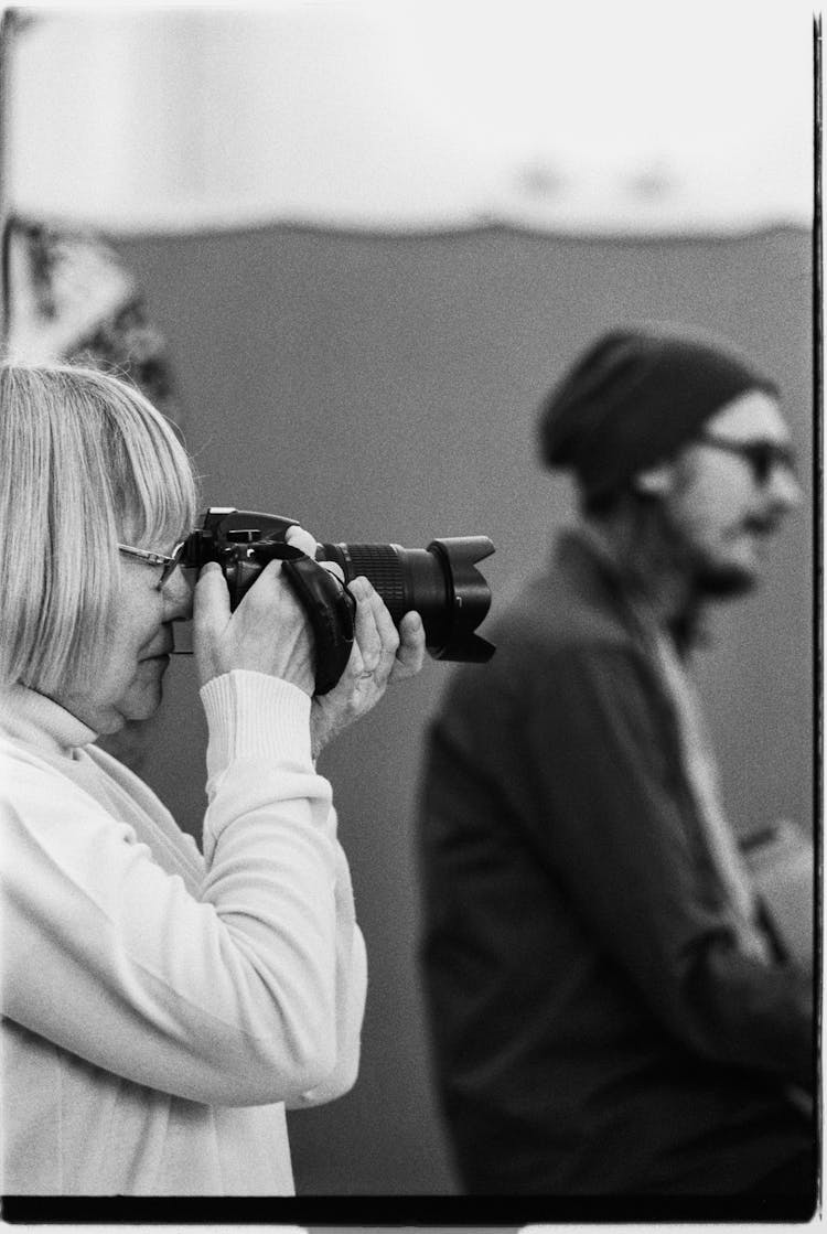 Elderly Woman Taking Photo With A Camera