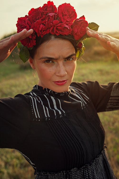 Woman in Fields Wearing Red Flower Crown