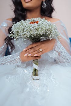 Close-up of a bride in a beautiful gown holding a white bouquet, captured in Addis Ababa.