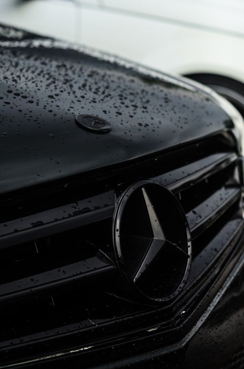 Free Detailed close-up of a wet black car grille with water droplets and emblem in Indonesia. Stock Photo