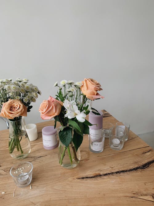 Flowers in Glass Vases on Top of a Wooden Table