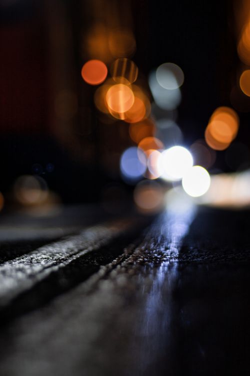 Free Blurred city night lights with urban street texture, creating a dreamy bokeh effect. Stock Photo
