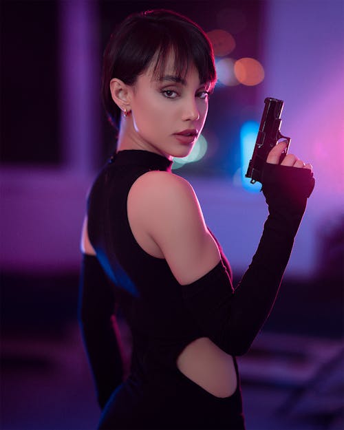 Portrait of Beautiful Woman Holding a Gun 