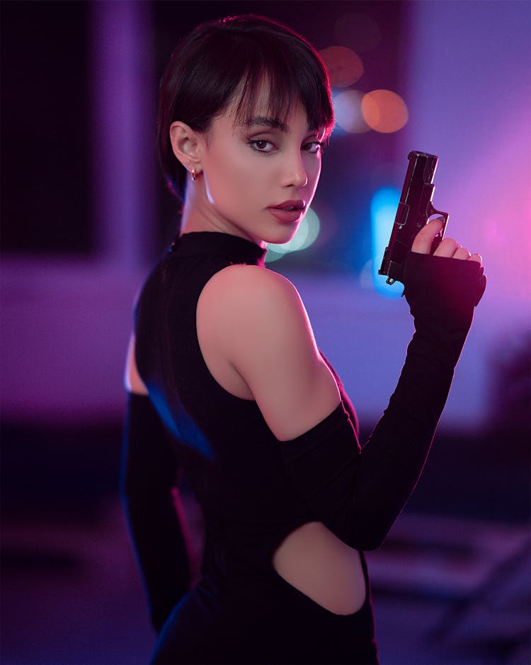 Portrait Of Beautiful Woman Holding A Gun 