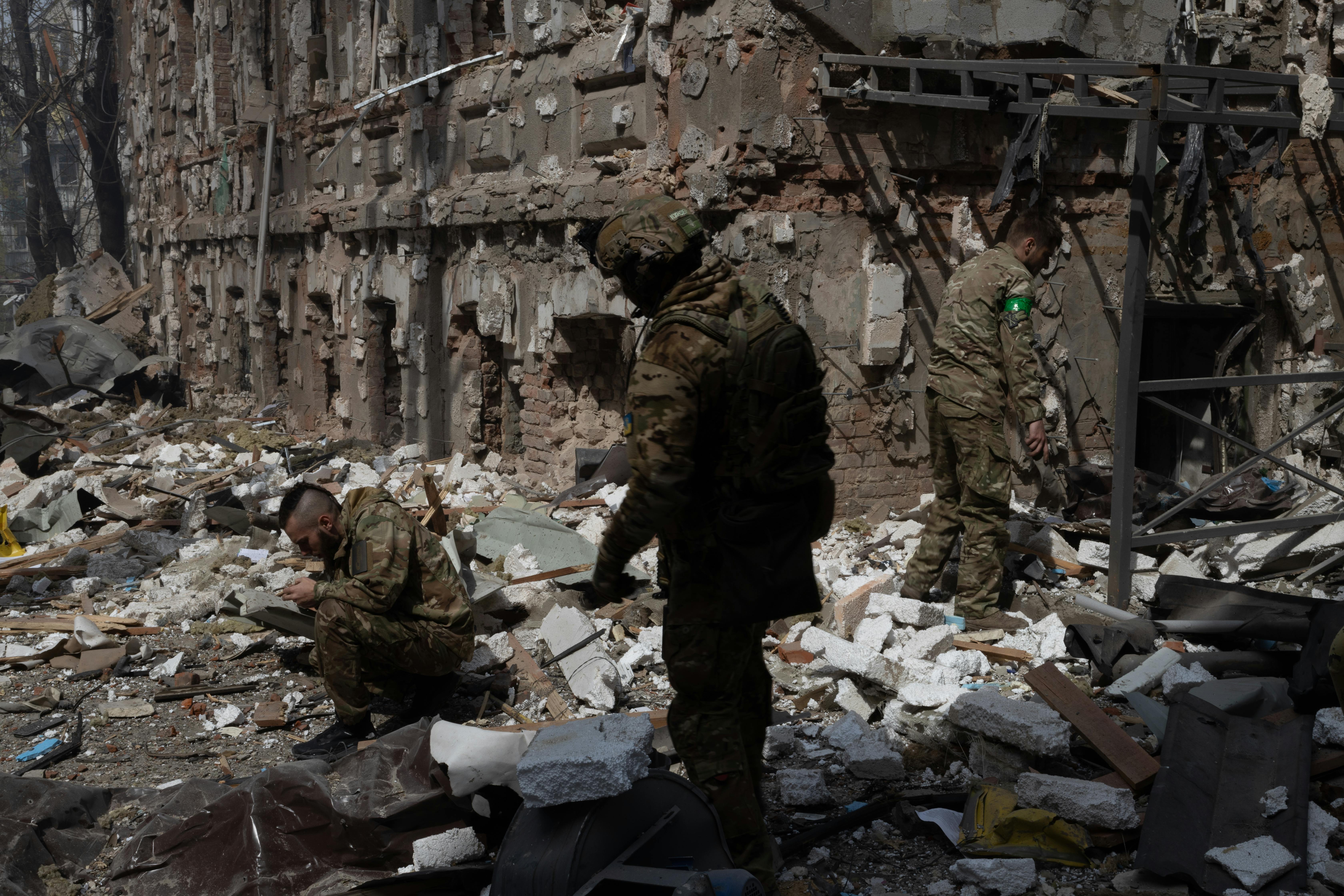 military personnel searching the wreckage