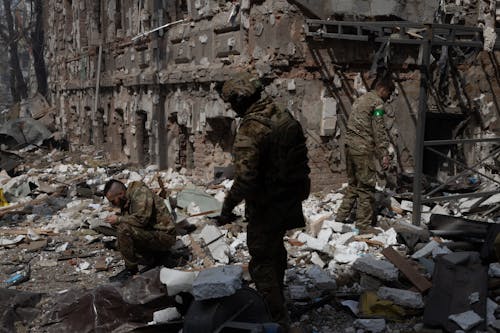 Free Military Personnel Searching the Wreckage Stock Photo