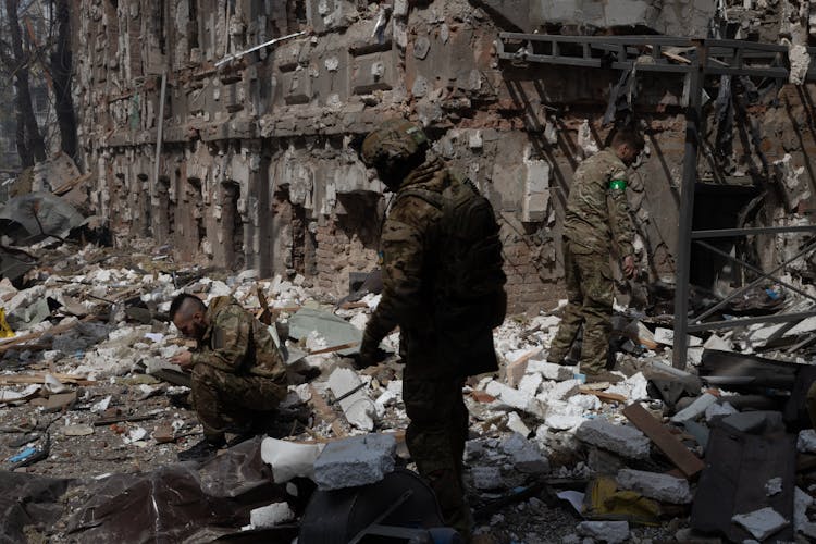 Military Personnel Searching The Wreckage