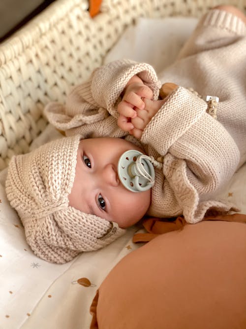 Free A Baby Lying Down with Pacifier Stock Photo