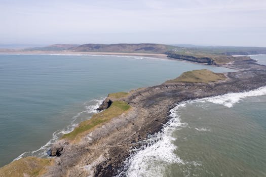 Stunning aerial view capturing the rugged coastline and natural beauty of Rhossili, Wales.
