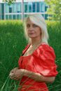 Woman in Red Dress Sanding Beside Tall Grass