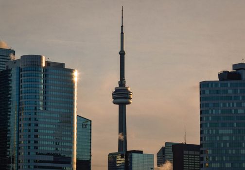 A stunning view of the Toronto skyline with the iconic CN Tower during sunset.