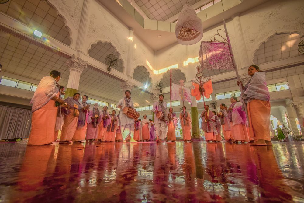 Dancers in traditional Indian attire performing in an Indian temple setting