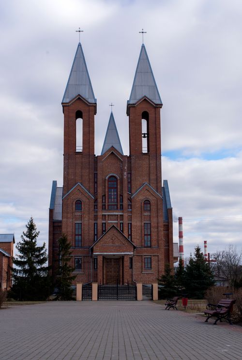 Free Captivating view of a Catholic church with brick facade and twin towers in Belarus. Stock Photo