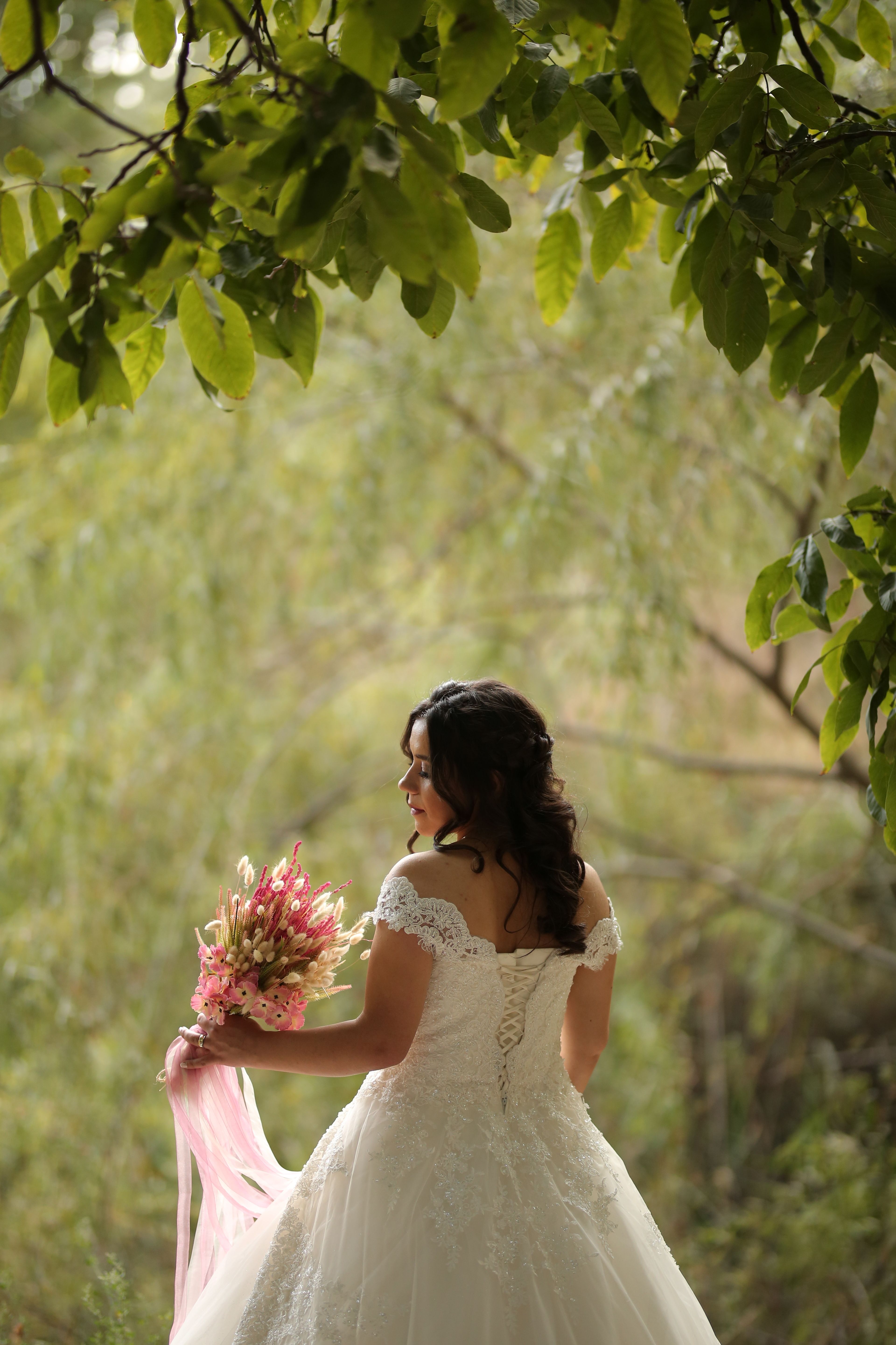 Woman in White Wedding Dress Holding Bouquet of Flowers · Free Stock Photo