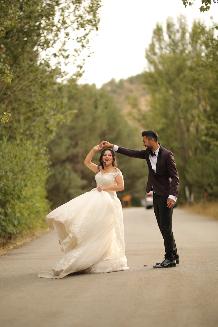 A Newlywed Couple Dancing On The Street