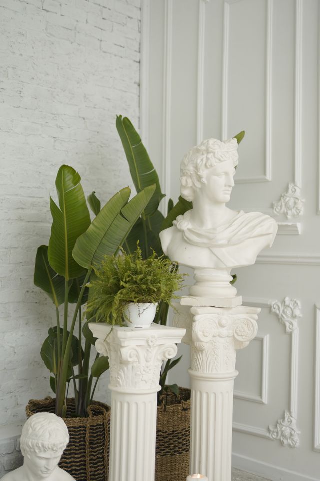 Classical bust beside lush greenery