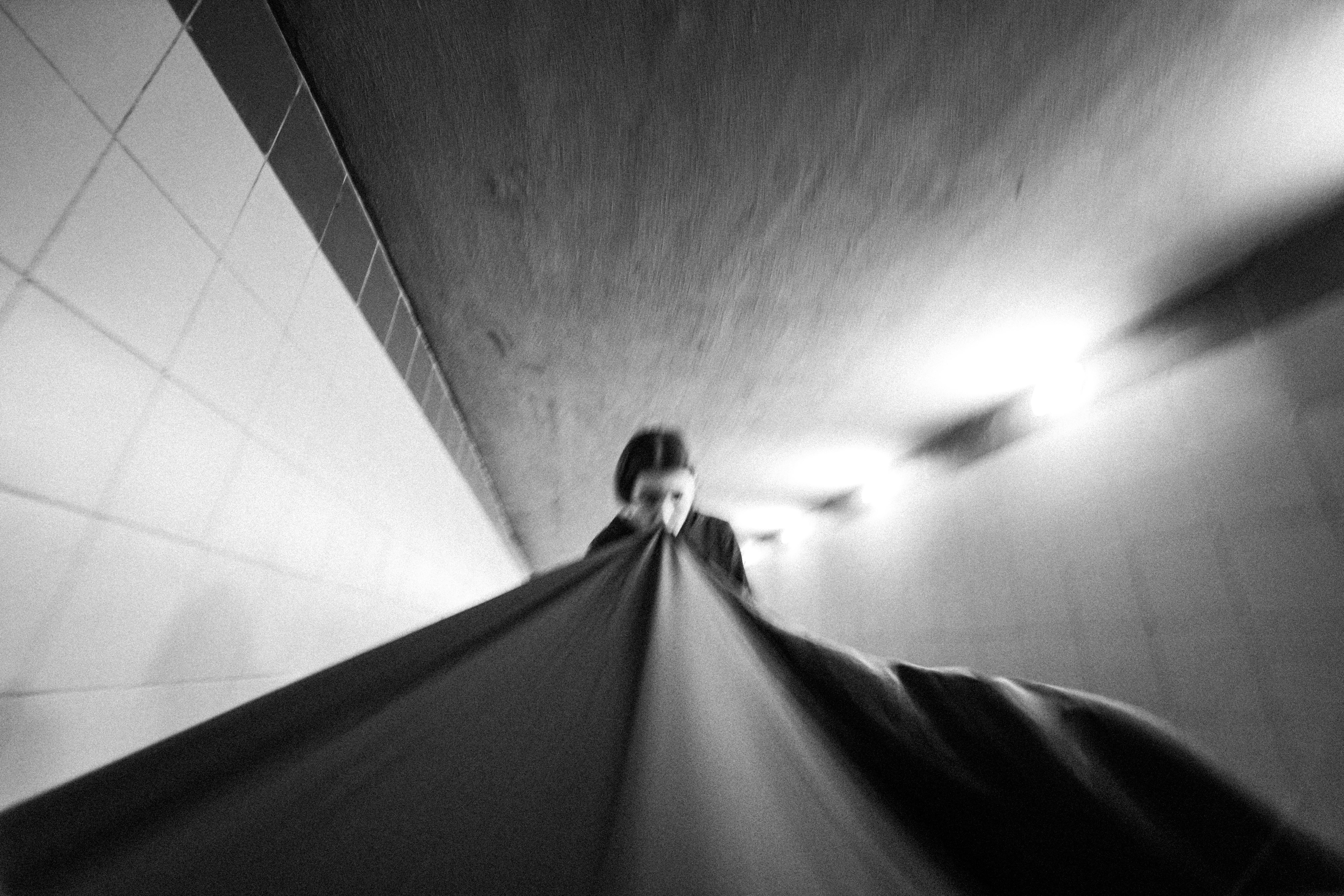 Abstract black and white photo of blurred motion in an underground tunnel with fabric.