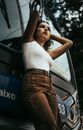 A Woman Standing Beside the Blue Bus