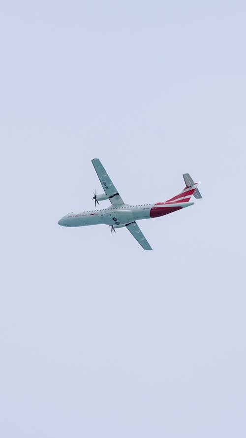 White and Red Airplane in Mid Air