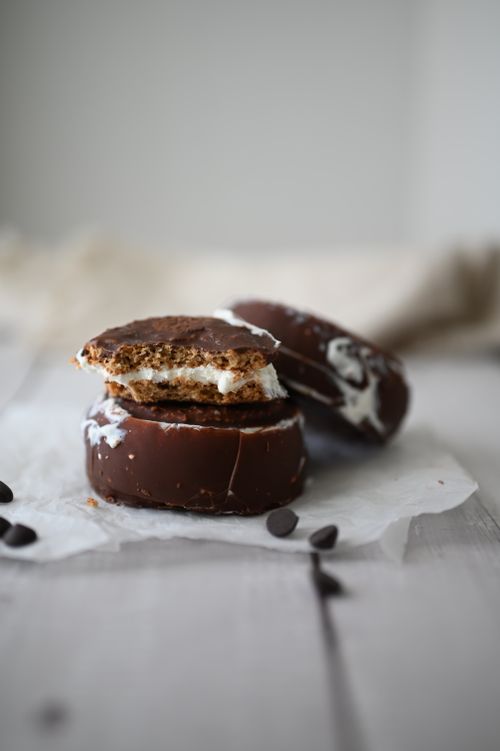 Free Close-up shot of chocolate moon pies placed on parchment paper, ideal for dessert themes. Stock Photo