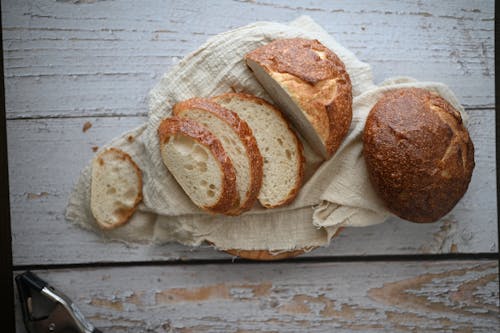 Free Sourdough Breads on White Woven Fabric  Stock Photo